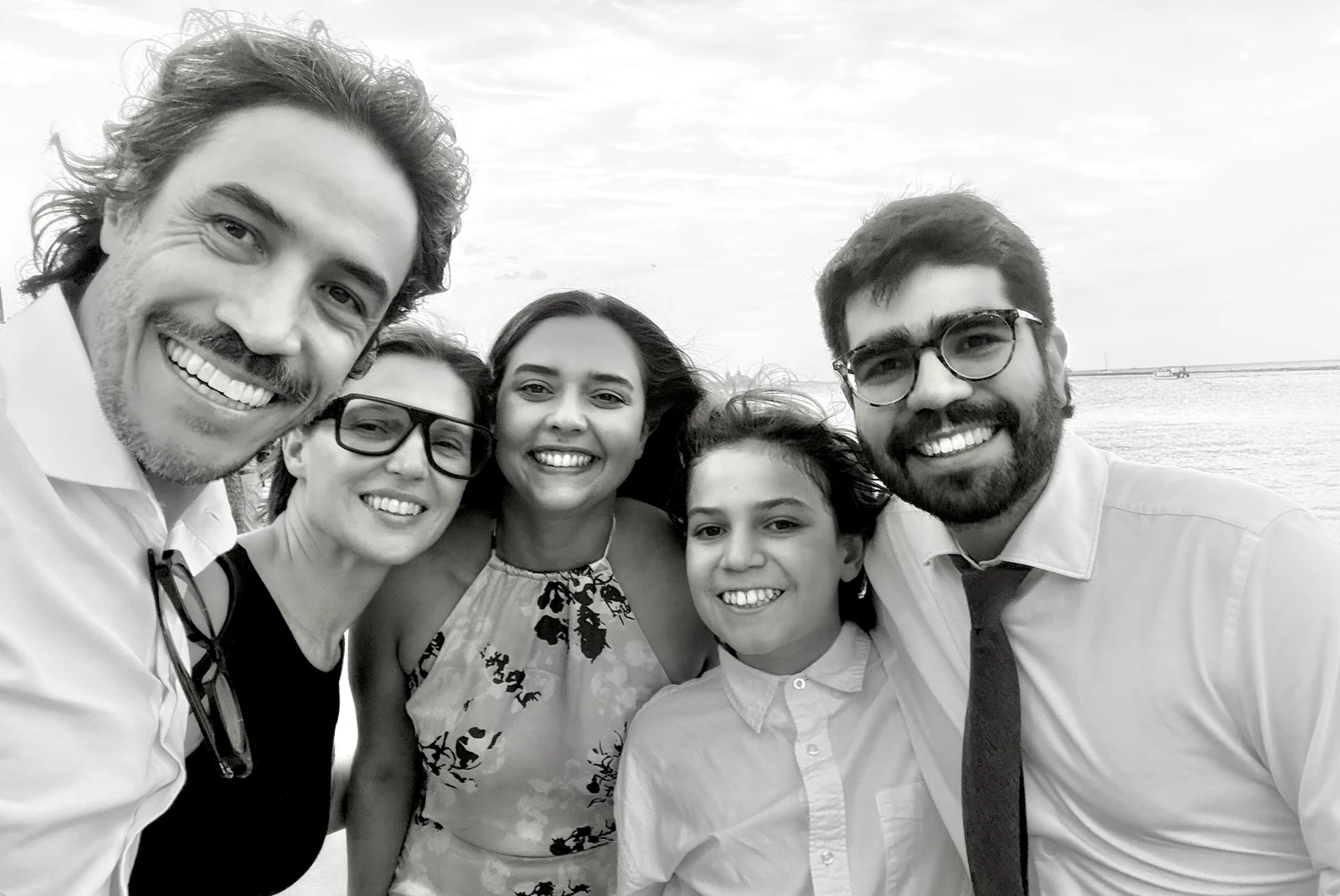 Black and white family photograph by the water